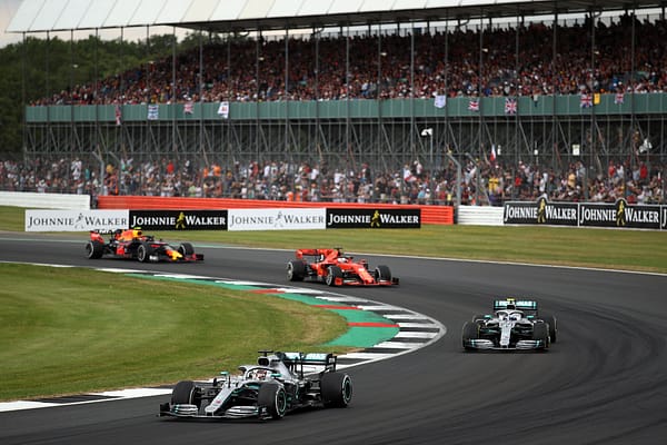 NORTHAMPTON, ENGLAND - JULY 14: Lewis Hamilton of Great Britain driving the (44) Mercedes AMG Petronas F1 Team Mercedes W10 leads Valtteri Bottas driving the (77) Mercedes AMG Petronas F1 Team Mercedes W10 on track during the F1 Grand Prix of Great Britain at Silverstone on July 14, 2019 in Northampton, England. (Photo by Bryn Lennon/Getty Images)
